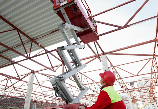 Construction Worker with Lift Equipment